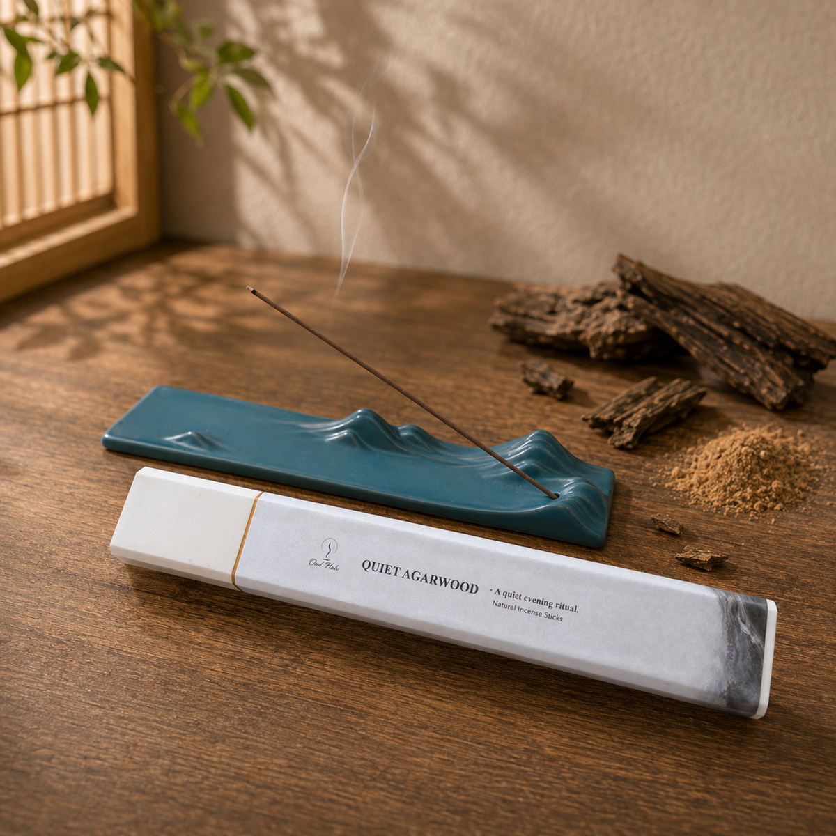 Quiet Agarwood 50g incense box with a dark green landscape holder and wood pieces